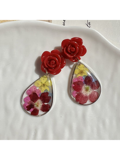 Model wearing Earwish Rose Teardrop Earrings with pink stones and silver hooks