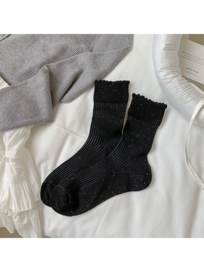 Side view of Rufia rib crew socks displaying ribbed cuff and speckled knit pattern