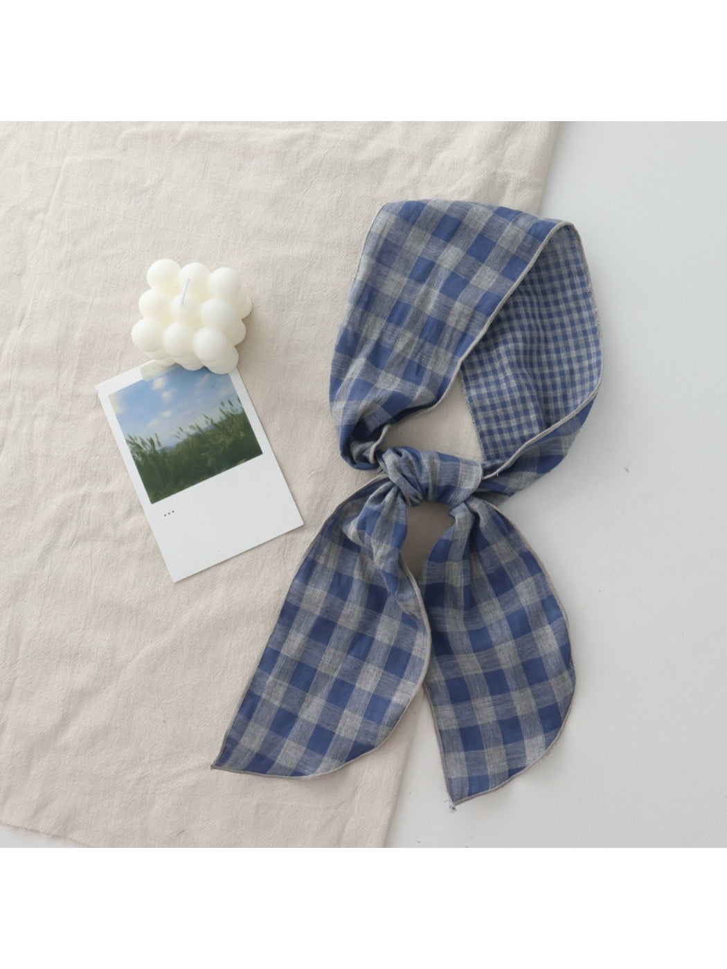 Model adjusting Scarvii Everyday Plaid Skinny Scarf outdoors in natural light