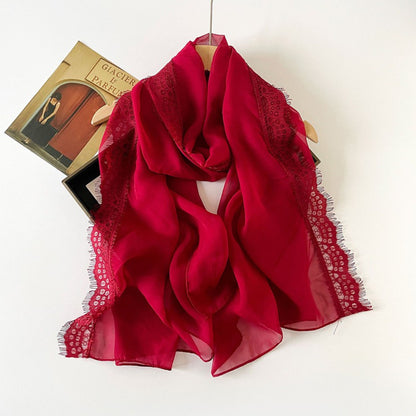 Lightweight scarf with lace border laid flat highlighting texture and pattern