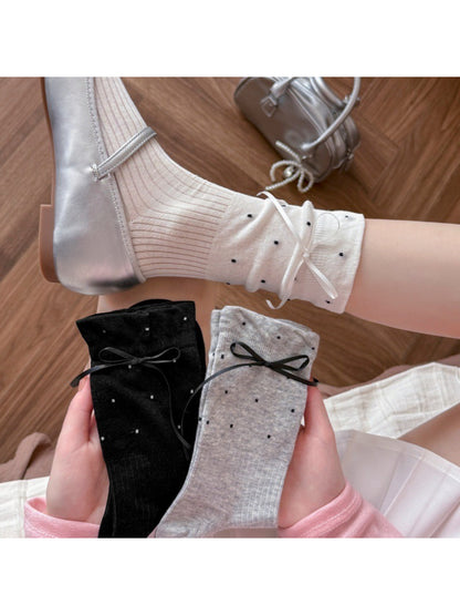 Pair of Rufia soft ribbed bow crew socks in light pink displayed flat