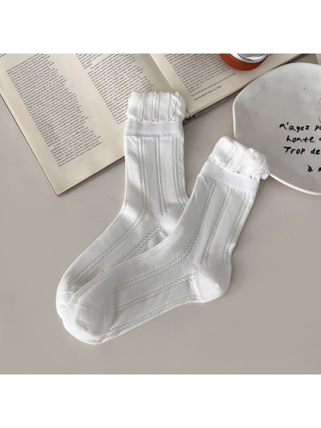 Side view of Rufia vintage pointelle crew socks highlighting ribbed cuff