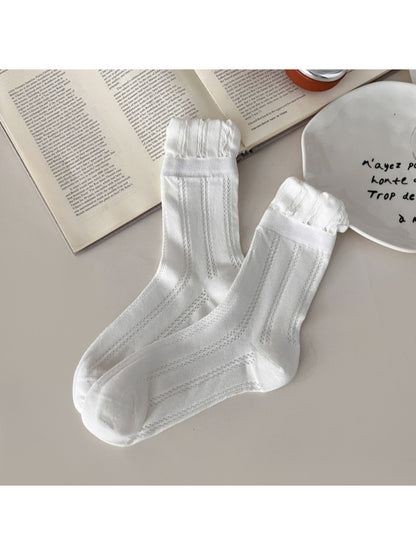 Side view of Rufia vintage pointelle crew socks highlighting ribbed cuff