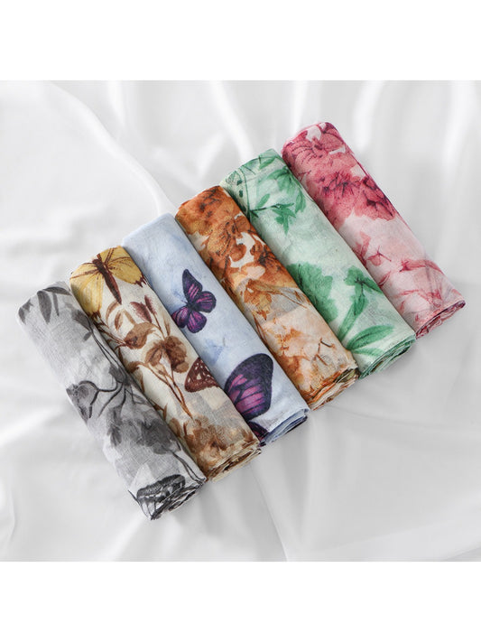 Lightweight scarf with botanical butterfly print draped on a white background