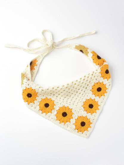 Close-up of sunflower crochet detail on hairband with mushroom beside it