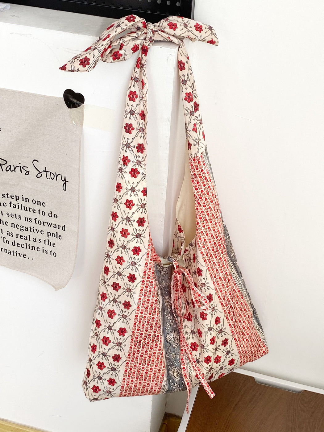 Cosbai boho tote bag placed on wooden surface with lighting