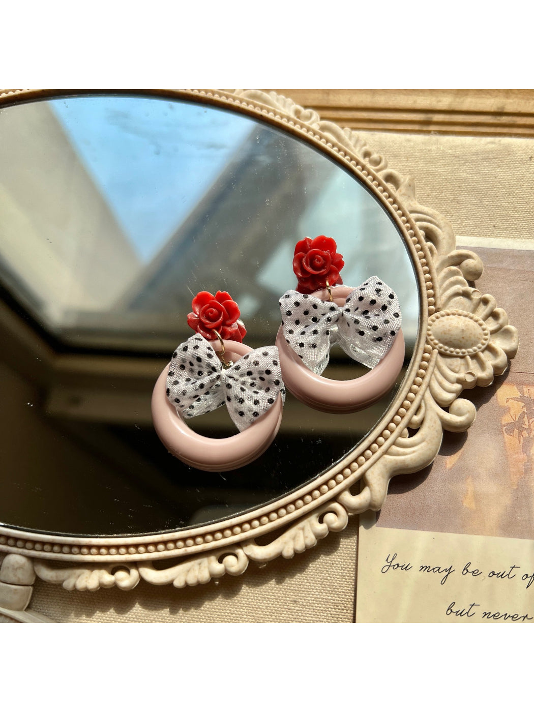 Model wearing Earwish Rose Bow Hoop Earrings showing size and style