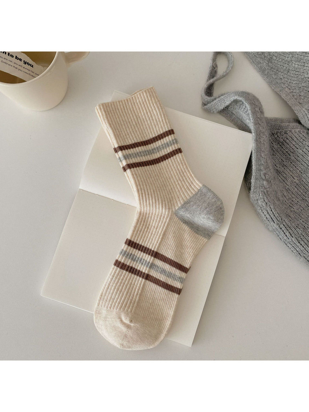 Rufia socks displayed with one sock folded to show inside texture and colour contrast