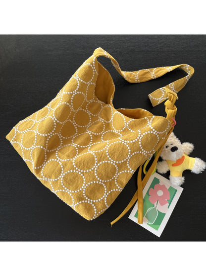 Cosbai tote bag displayed with dog charm hanging from shoulder strap