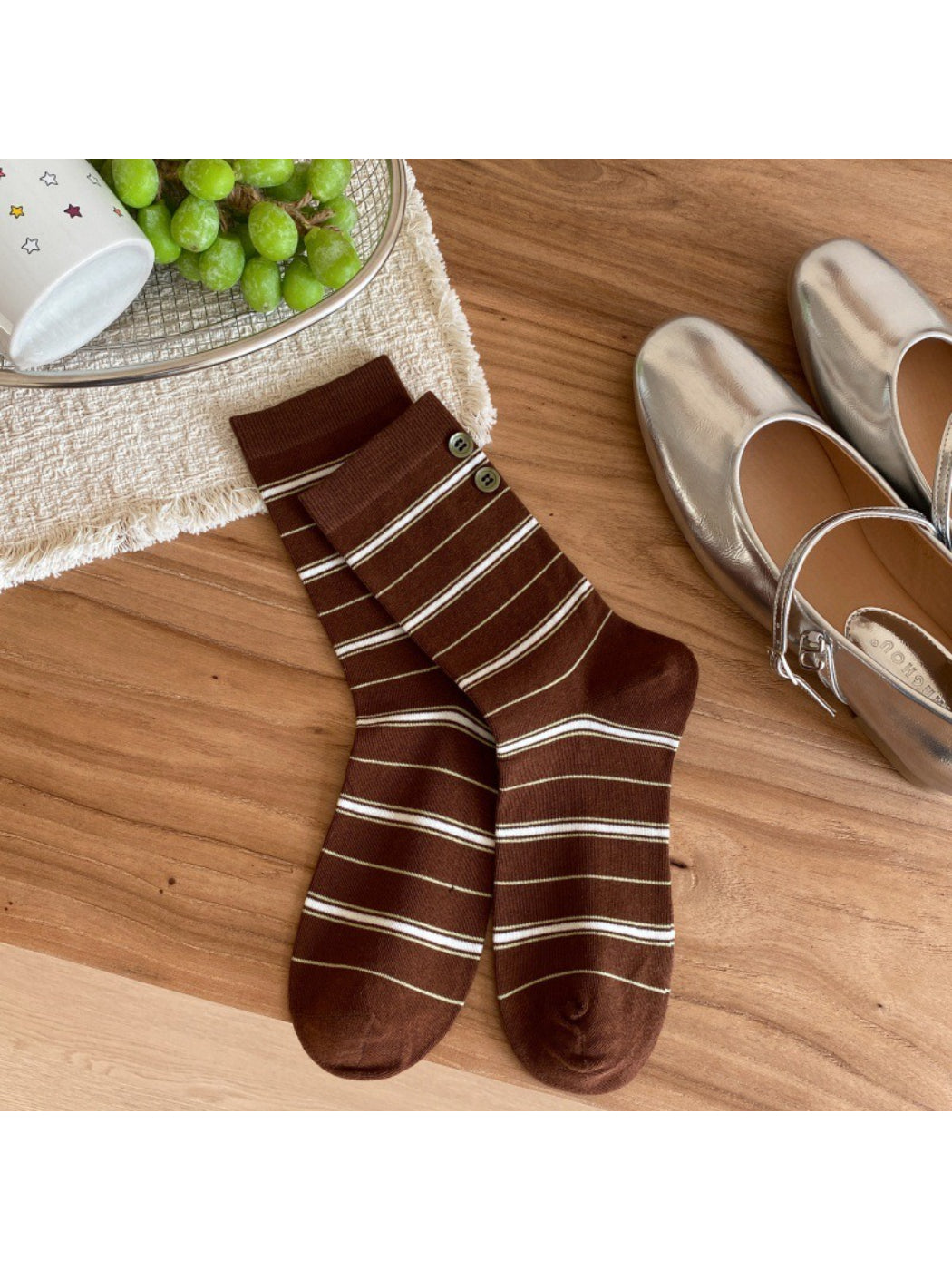 Rufia ribbed socks in pastel pink displayed on wooden surface