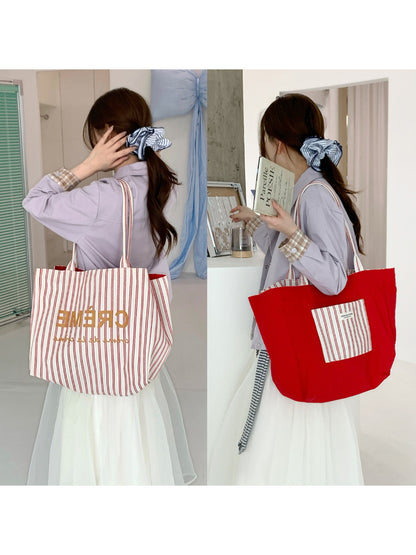 Close-up of Cosbai tote bag showing striped graphic design and handles