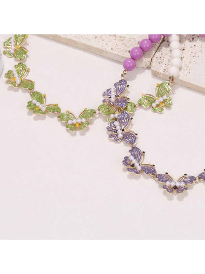 Neckit Butterfly Necklace with beaded detail displayed on a black surface