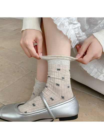 Rufia ribbed crew socks displayed flat showing bow pattern on fabric