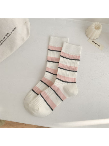 Model wearing Rufia crew socks paired with casual shoes, showcasing stripe design