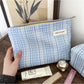 Close-up of Cosbai blue check cosmetic bag showing fabric pattern and texture