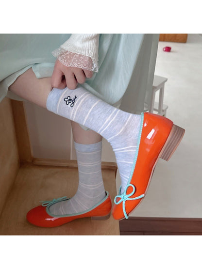 Rufia pastel stripe knit socks worn on feet with visible ribbed cuff