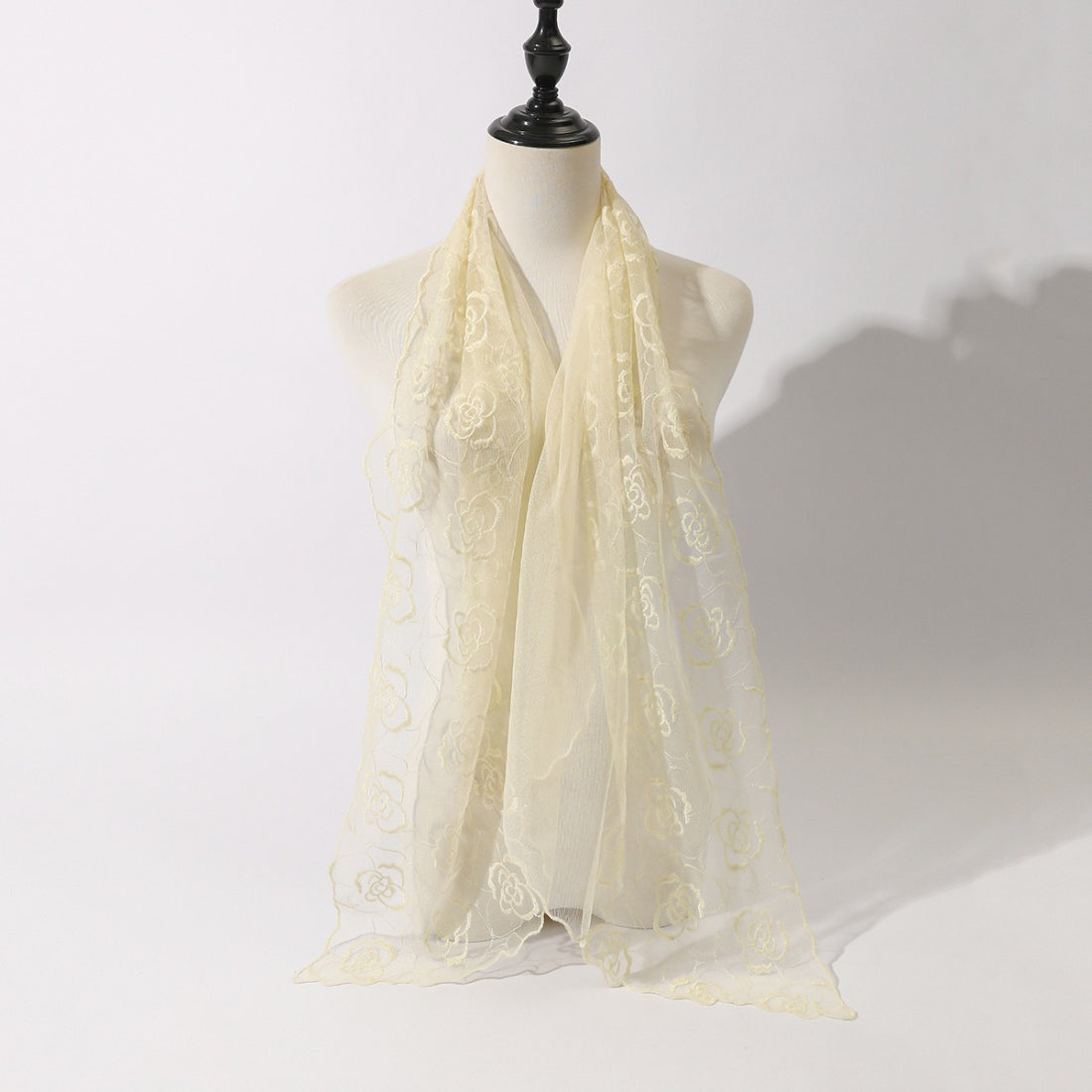 Model wrapping Scarvii floral sketch tulle shawl scarf around shoulders