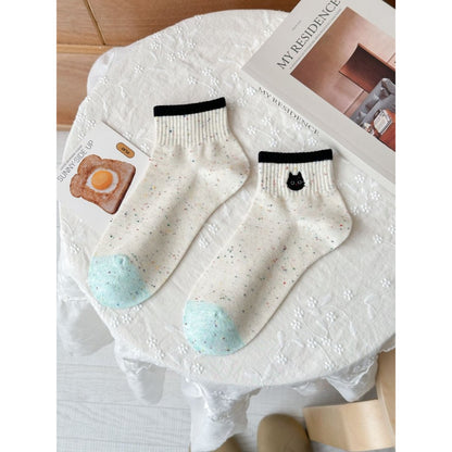 Side view of Rufia speckled knit crew socks highlighting ribbed cuff