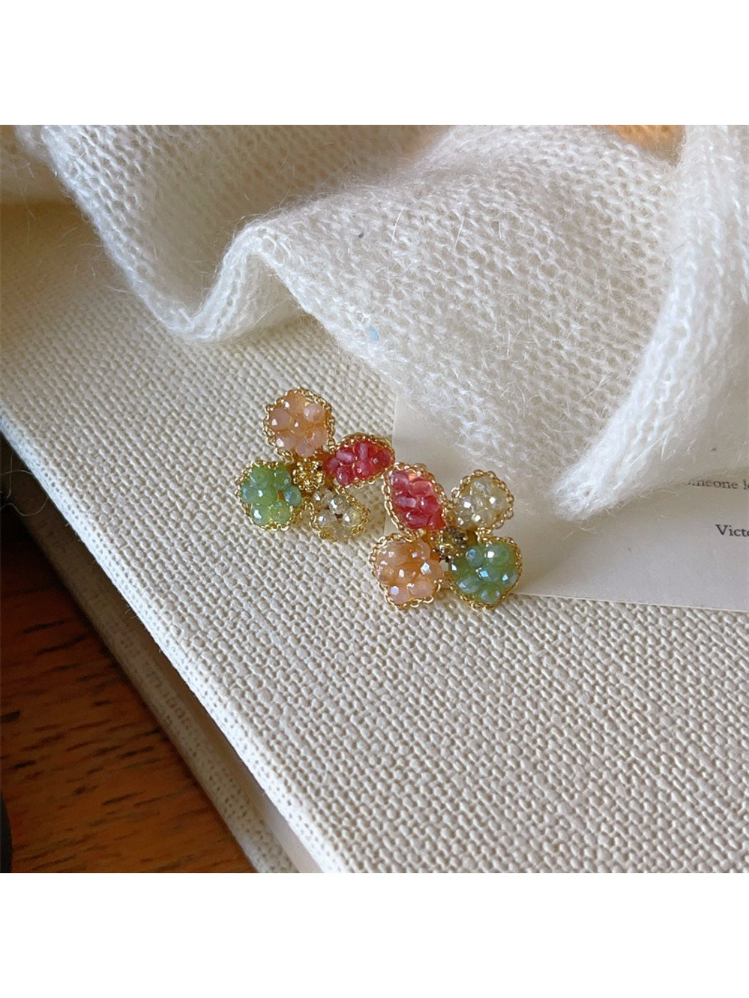 Earwish Crystal Blossom Cluster stud earrings worn on an ear, highlighting size and sparkle