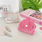 Close-up of button detail on Cosbai Soft Dot Button Coin Purse in beige