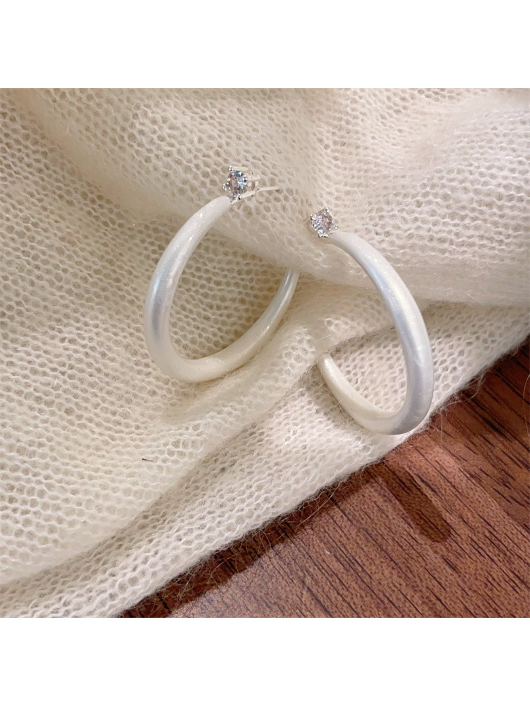 Glossy color hoop earrings arranged in a circular pattern