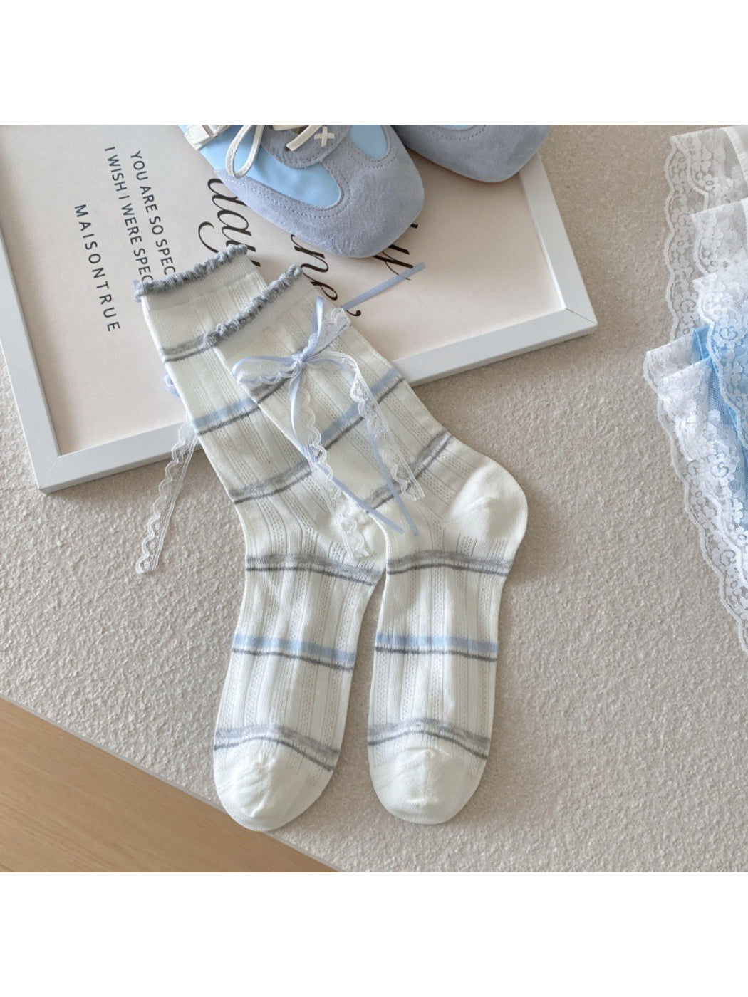 Side view of Rufia Sweet Blue and Grey crew socks on a model