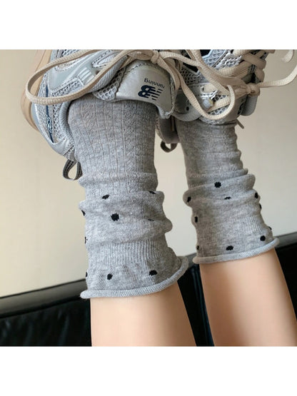 Pair of Rufia ruffle mesh dot mid-calf socks worn on feet with visible dot pattern