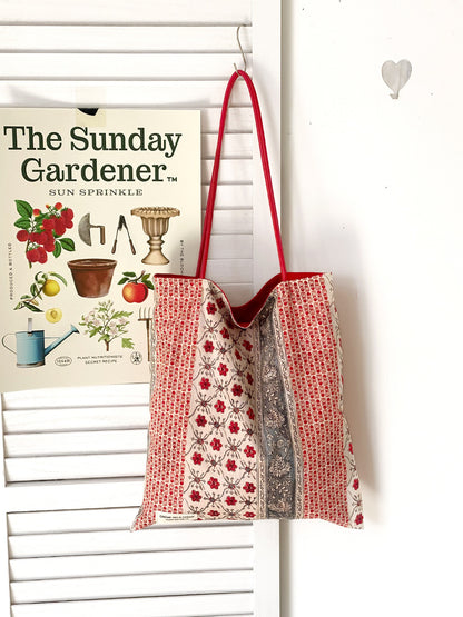 Cosbai floral patchwork tote bag hanging on a hook with visible fabric texture