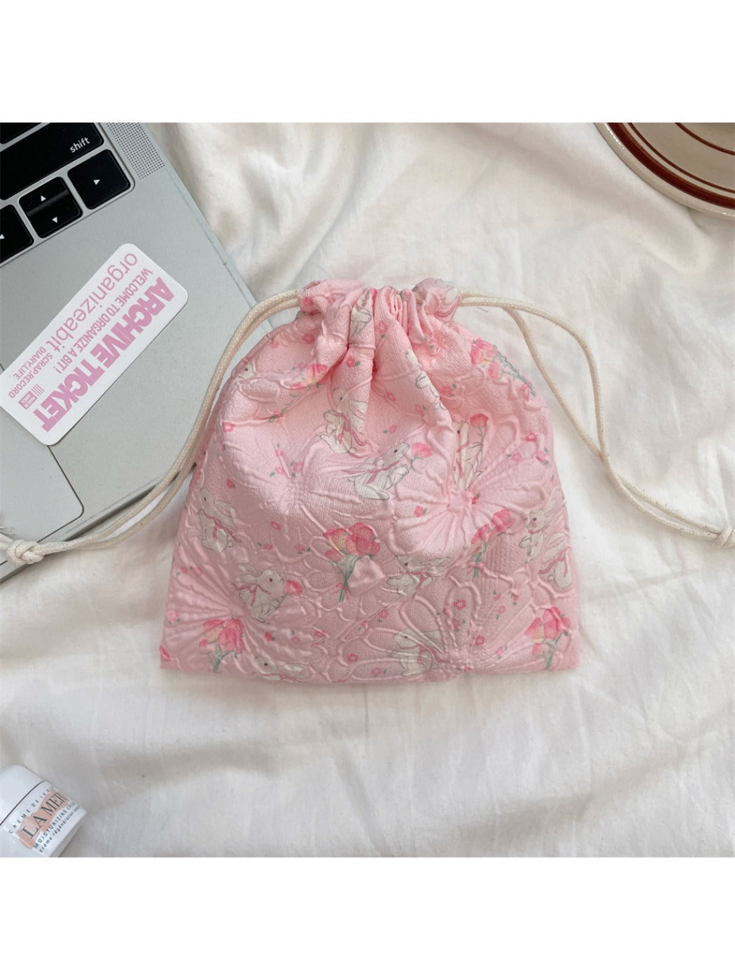 Cosbai cartoon drawstring pouch with drawstrings pulled and pouch gathered