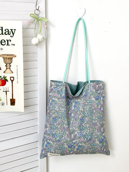 Cosbai tote bag with patchwork floral design displayed on a white background