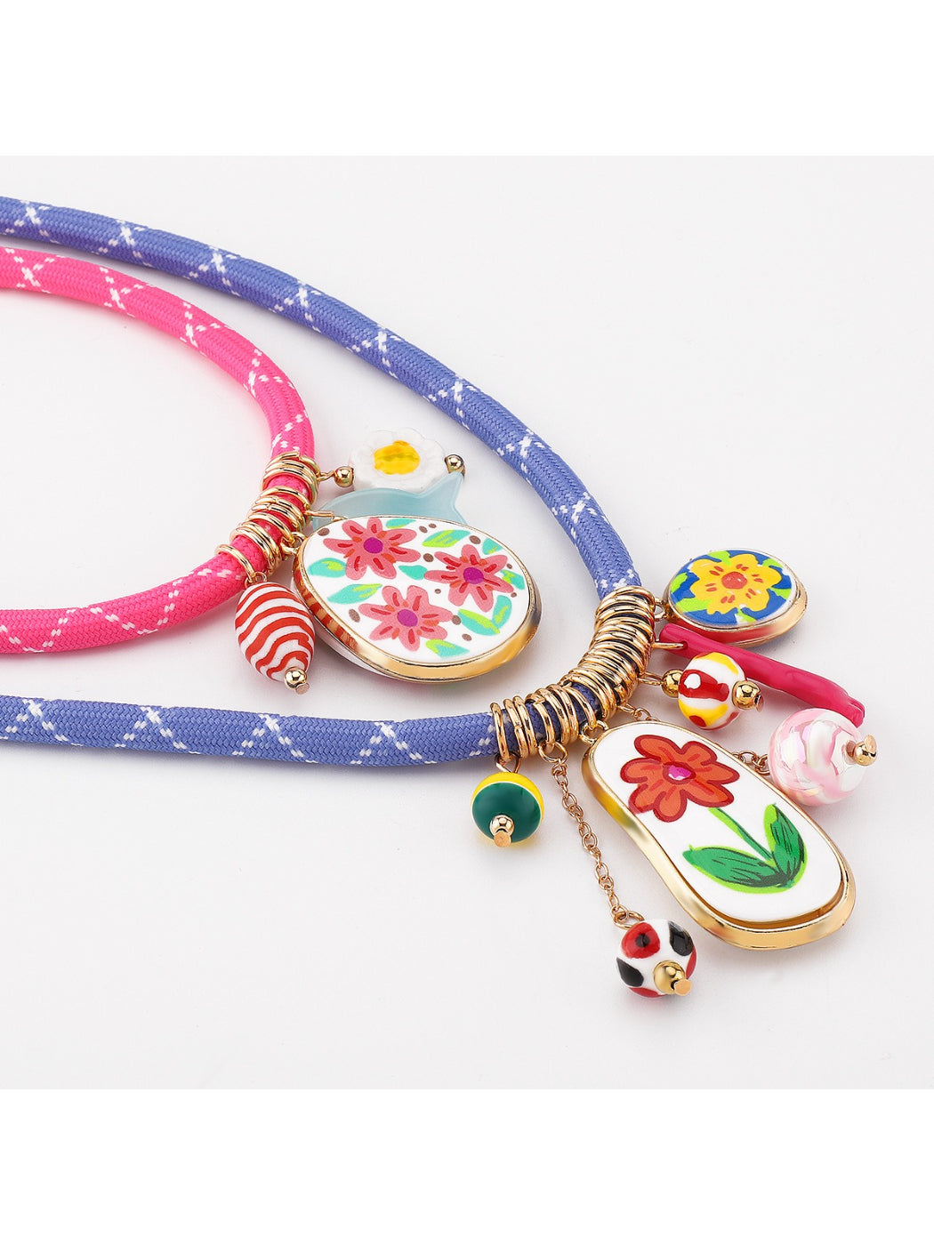 Multi charm rope necklace worn on a model showcasing vibrant colours and charm arrangement