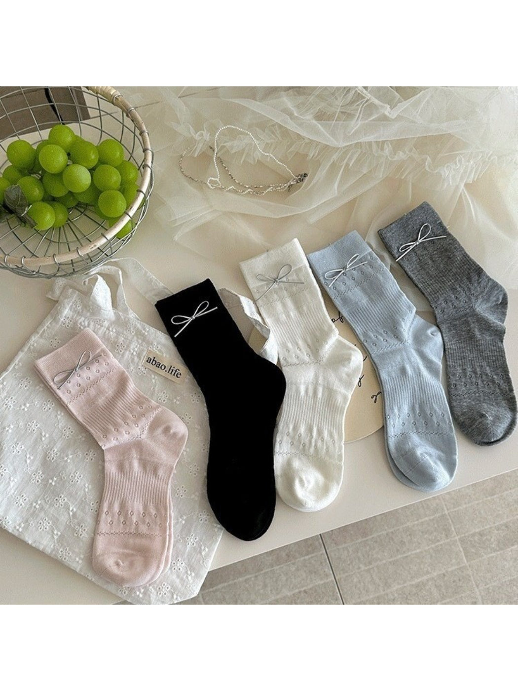 Close-up of Rufia delicate bow texture socks in soft pastel color