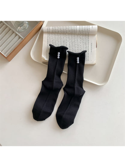 Rufia crew socks displayed flat showing full length and bead accents