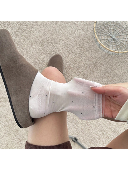 Rufia soft polka mesh socks worn with black shoes and cropped pants