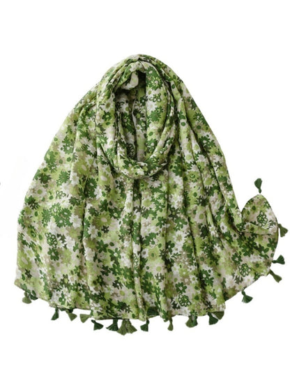 Model wearing bright ditsy floral wrap scarf styled around neck