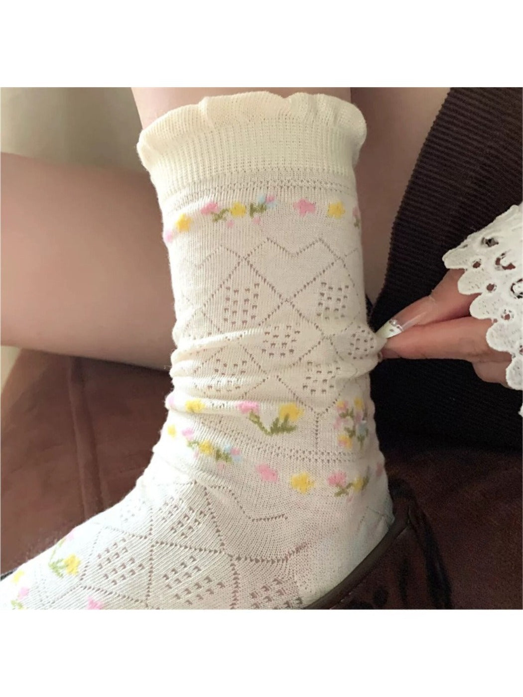 Model wearing Rufia floral pointelle crew socks with casual shoes and cropped pants