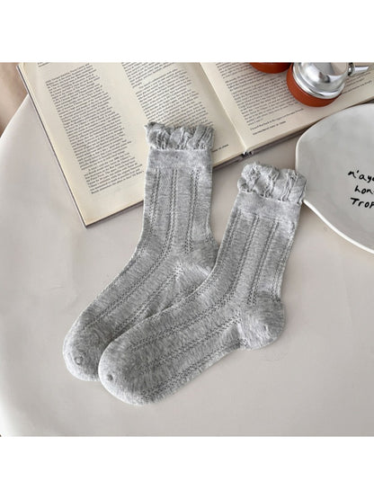 Rufia vintage pointelle crew socks folded neatly on wooden surface