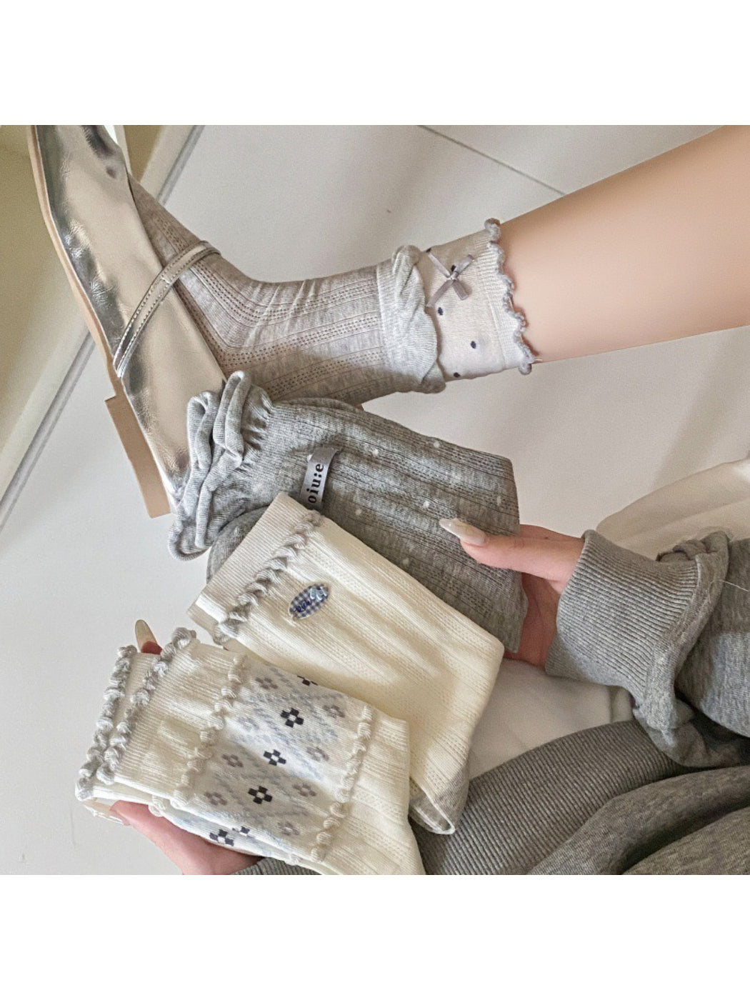 Pair of Rufia Sweet Blue and Grey crew socks laid flat showing front design