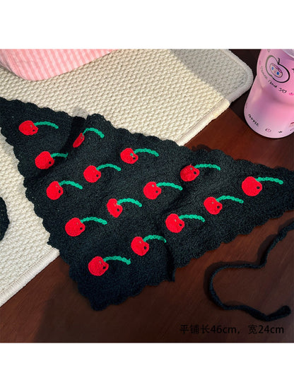 Close-up of Scarvii crochet headband showing detailed fruit pattern and textured yarn