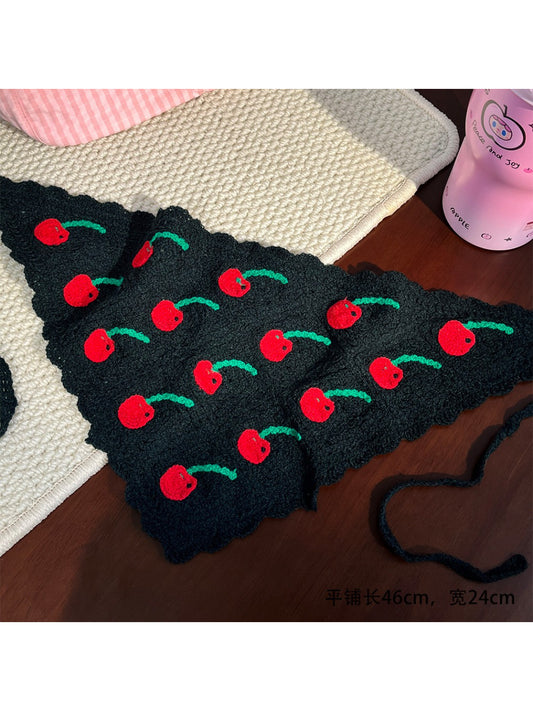 Close-up of Scarvii crochet headband showing detailed fruit pattern and textured yarn
