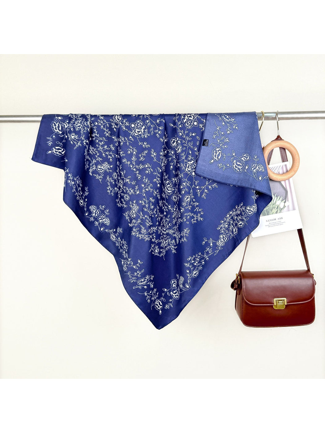 Scarvii bandana styled as a headband featuring green vine and floral motifs