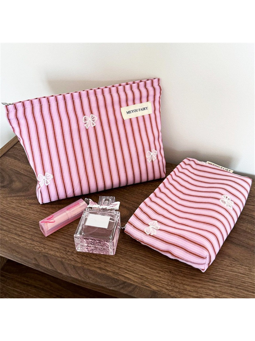 Pink stripe butterfly makeup bag on white background