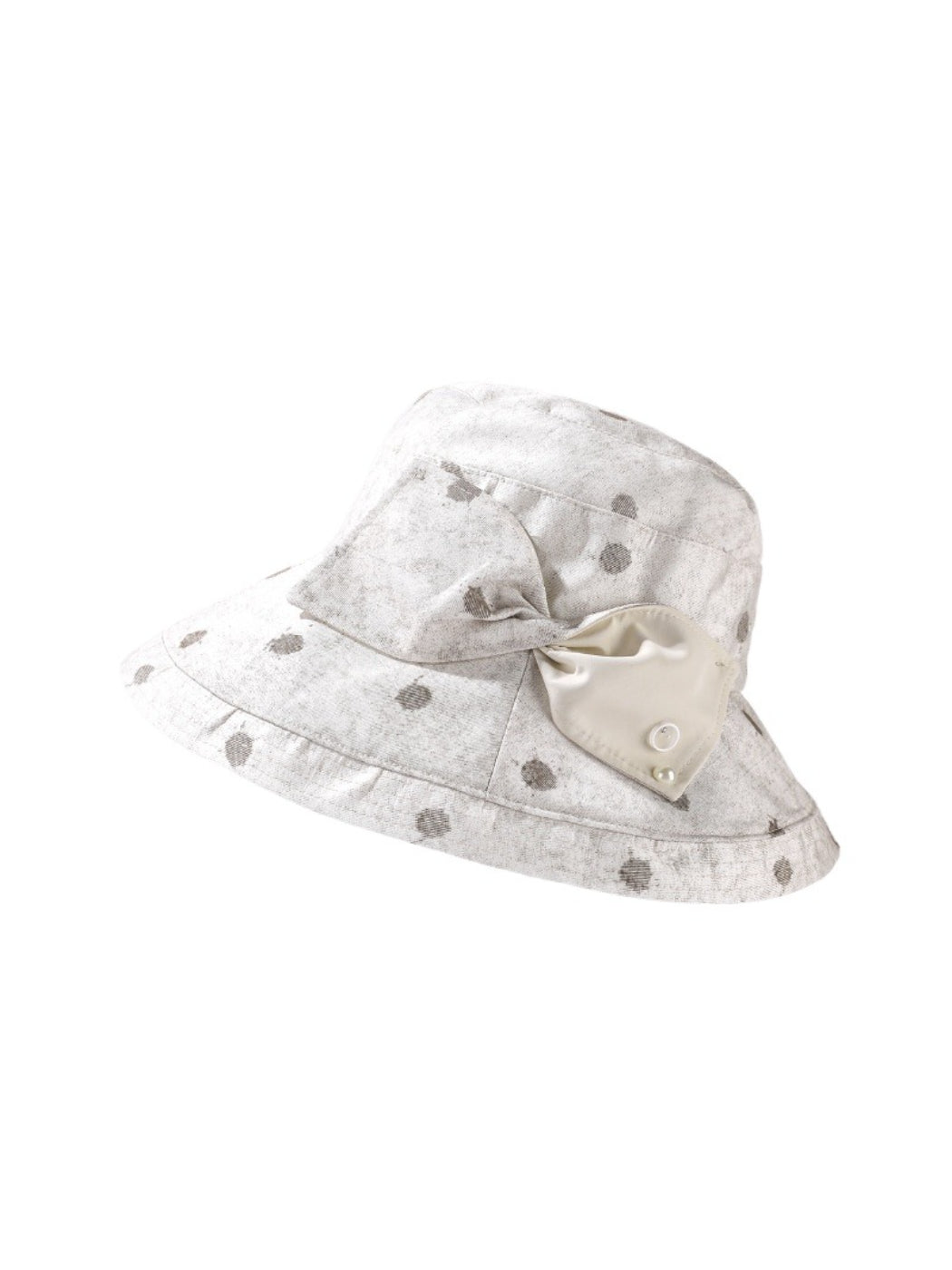 Close-up of Haila hat fabric with black polka dots on white background