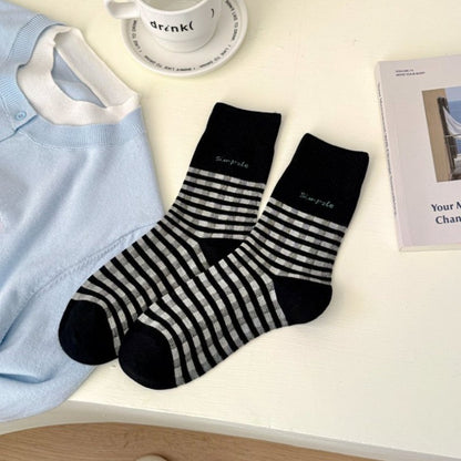 Side view of Rufia fine stripe crew socks highlighting ankle length fit