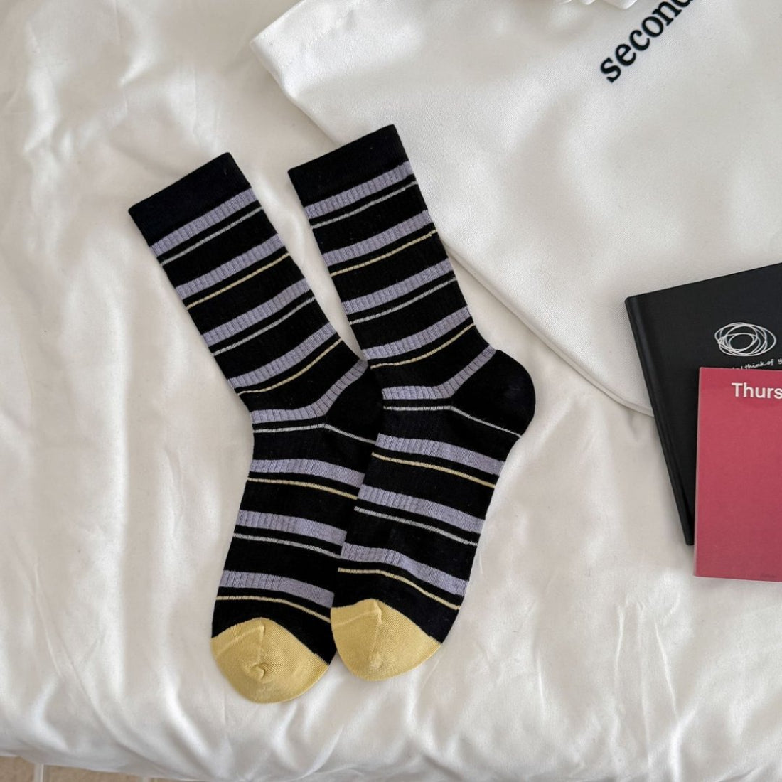 Side view of Rufia ribbed socks highlighting the striped design and ankle length