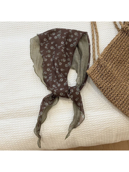 Botanical triangle scarf showing detailed leaf and flower patterns