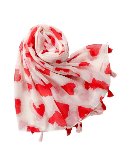 Model wearing Scarvii Heart Print Tassel Scarf styled around the neck