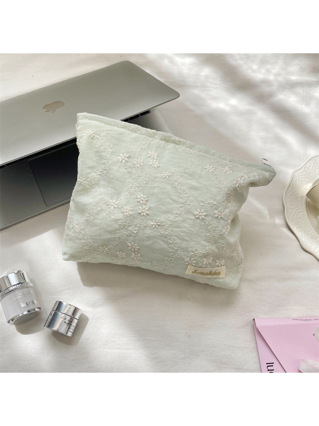 Cosbai cosmetic pouch placed on a white surface with lighting
