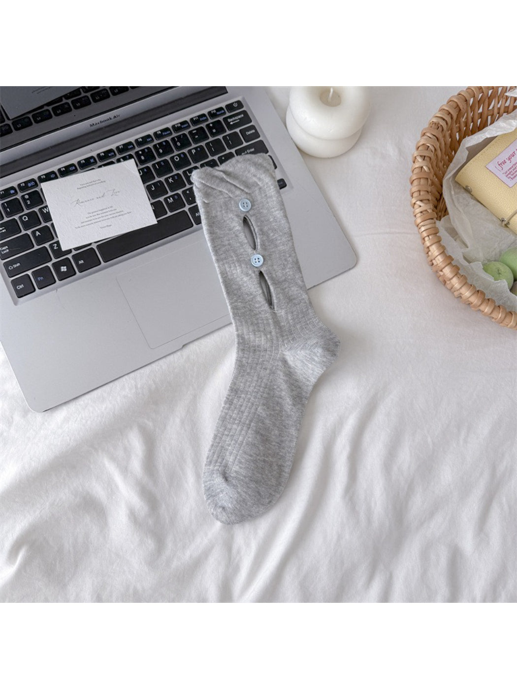 Rufia button cut out crew socks in white, angled view showing texture and buttons