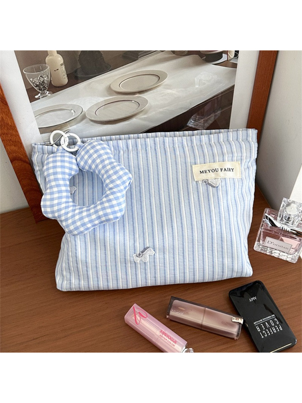 Striped cosmetic bag open displaying interior compartments